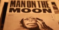 a close up of a newspaper with a monkey on it