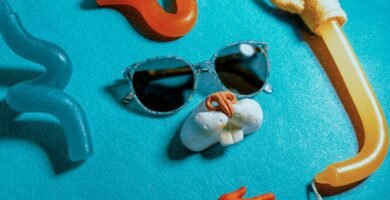 black sunglasses on teal textile